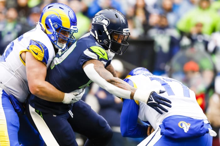 Jan 8, 2023; Seattle, Washington, USA; Seattle Seahawks linebacker Bruce Irvin (51) sacks Los Angeles Rams quarterback Baker Mayfield (17) during the first quarter at Lumen Field. Los Angeles Rams center Coleman Shelton (65) attempts to block Irvin at left.